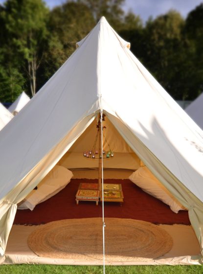 GlampingTen beautiful Bell tents with proper beds, rich cotton sheets and vintage furniture.